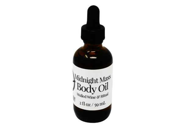 A 2 oz glass dropper bottle of Midnight Mass Body Oil with a black label and dropper, set against a black background.